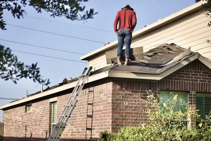 Professional roofer working on a residential roof in Texas City